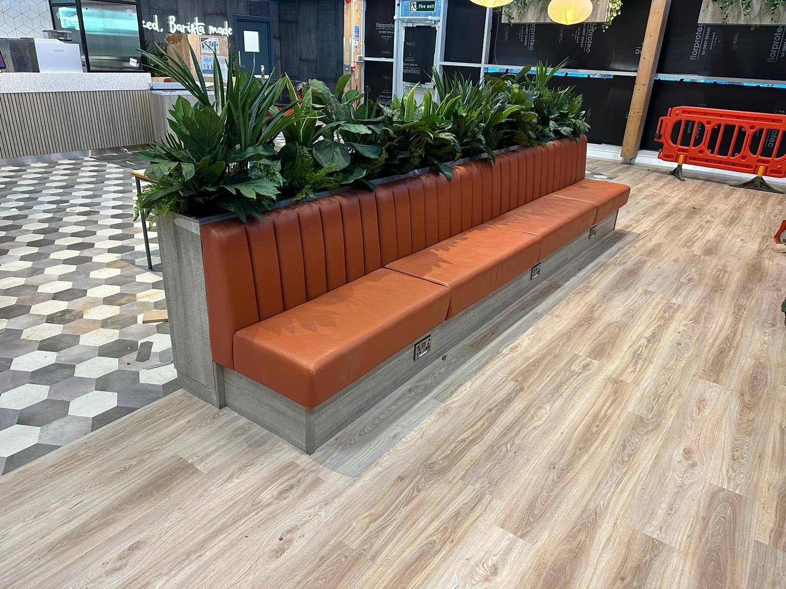 Fixed seating with faux plants